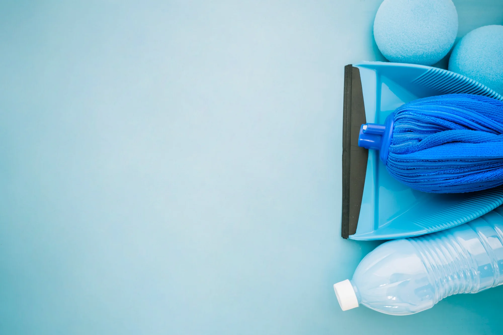 Fresh cleaning tools in a bright blue setting